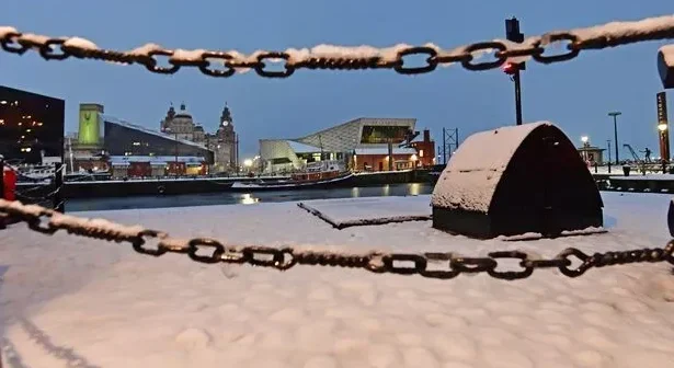 Snow falls on the Liverpool waterfront on the Royal Albert Dock. Photo by Colin Lane