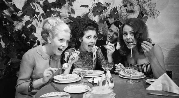 Spaghetti eating lessons for customers at La Bussola Italian restaurant in Bold Street, Liverpool, given by owner Franco Bertolasi of Intra, Lake Maggiore, Italy. Picture shows customers left to right: Ann Sidney, Vicky Woolf and Linda Beni tucking in to their dish of spaghetti as Mr Bertolasi looks on. August 15, 1967