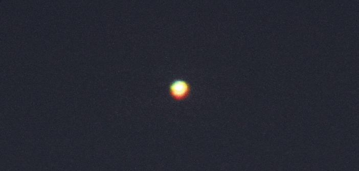 Looped video footage of a green flash coming from Venus in the night sky