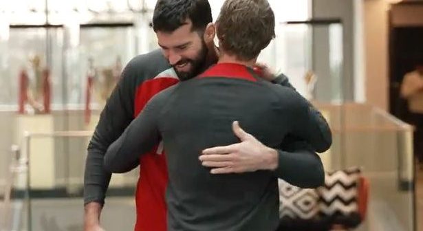 Alisson Becker embraces Liverpool's head of fitness & conditioning, Andreas Kornmayer, at the AXA Training Centre