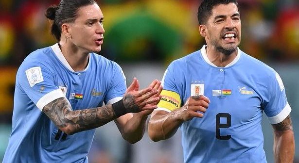 Luis Suarez and Darwin Nunez of Uruguay protest to Referee Daniel Siebert after awarding a penalty to Ghana after the video assistant referee review the during the FIFA World Cup Qatar 2022 Group H match between Ghana and Uruguay at Al Janoub Stadium
