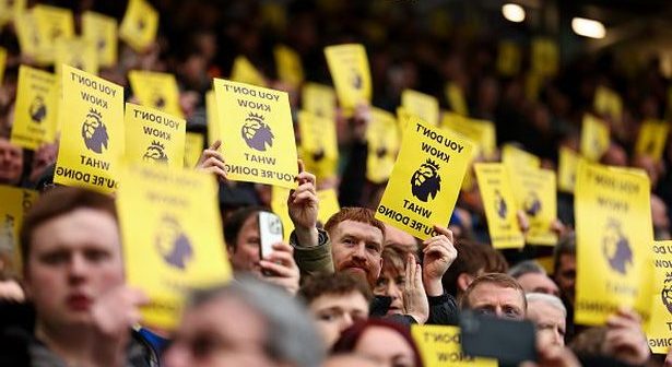 LIVERPOOL, ENGLAND - FEBRUARY 3: Fans of Everton hold up pieces of paper with a message on in protest against the Premier League ahead of the Premier League match between Everton FC and Tottenham Hotspur at Goodison Park on February 3, 2024 in Liverpool, England. (Photo by Robbie Jay Barratt - AMA/Getty Images)