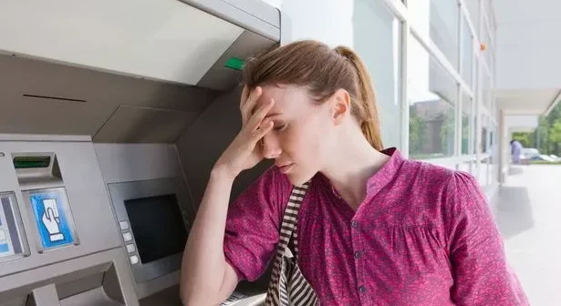 a woman at an ATM (cash machine)