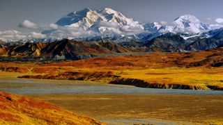 Autumn colors paint the landscape below the mighty Mount McKinley (Denali).